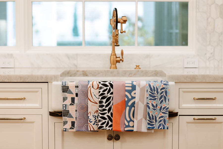 Patterned Tidy Towel kitchen towels hanging over a farmhouse sink